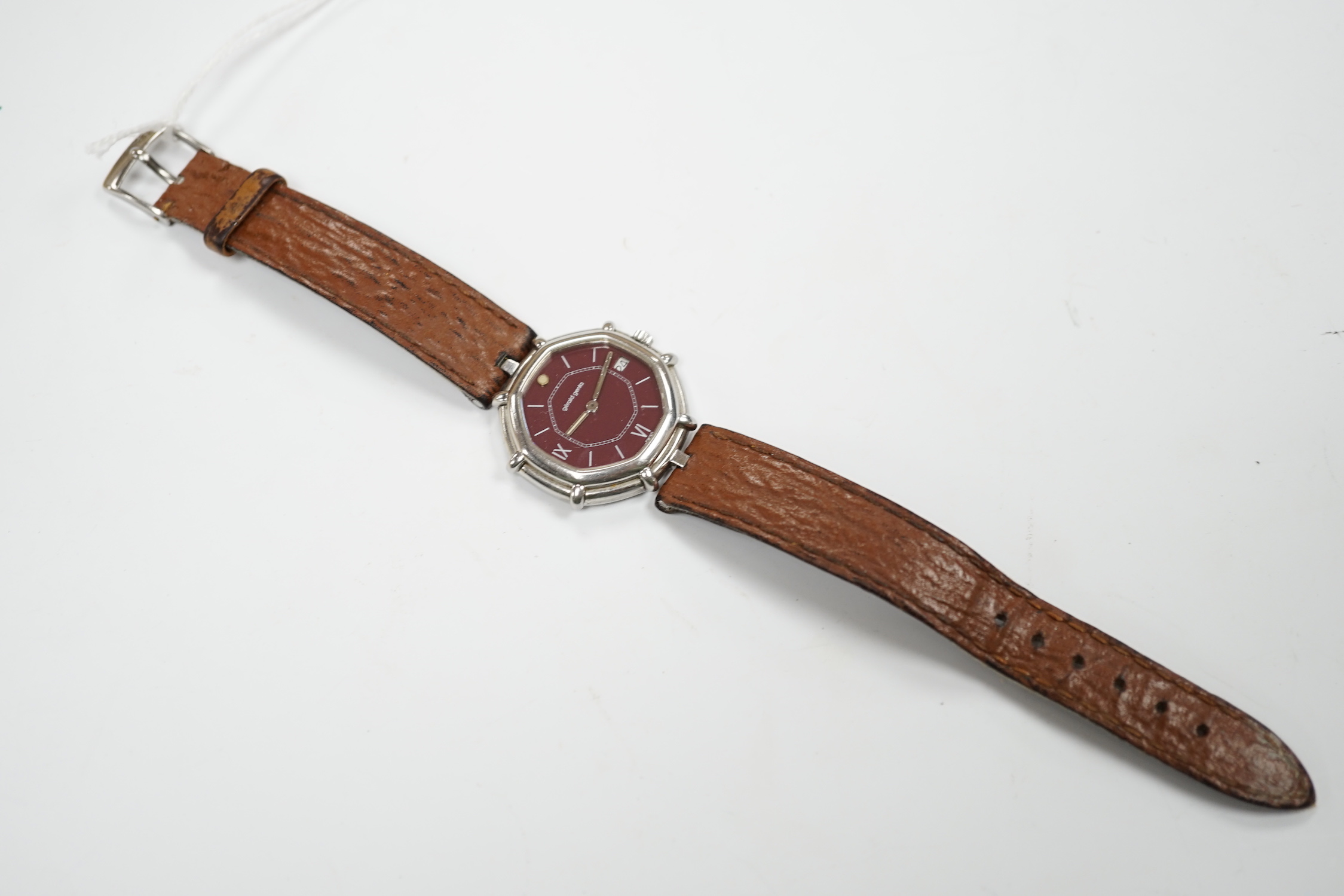 A gentleman's Swiss stainless steel Gerald Genta quartz octagonal wrist watch, with burgundy dial and Roman and baton numerals, on a leather strap, case diameter 32mm, with original box, leather pouch and guarantee.